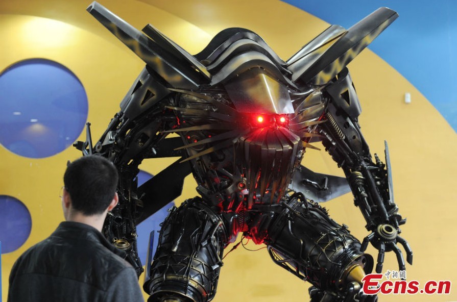 A robot statue is on display at an exhibition featured on characters of the American science fiction action film Transformers in Chengdu, Southwest China's Sichuan Province, March 19, 2013. The statues were made of parts from written-off vehicles. (CNS/Zhang Lang)