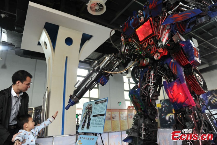 A robot statue is on display at an exhibition featured on characters of the American science fiction action film Transformers in Chengdu, Southwest China's Sichuan Province, March 19, 2013. The statues were made of parts from written-off vehicles. (CNS/Zhang Lang)