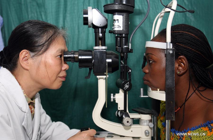 Chinese ophthalmologist Ning Peilan (L) examines a Gabonese patient in Libreville, capital of Gabon, Nov. 9, 2007. The China-Africa strategic cooperation has created a promising win-win scenario for the world's largest developing country and the fast-emerging continent over past decades. Chinese President Xi Jinping will visit Tanzania, South Africa and the Republic of Congo later this month and attend the fifth BRICS summit on March 26-27 in Durban, South Africa. (Xinhua/Wang Ying) 