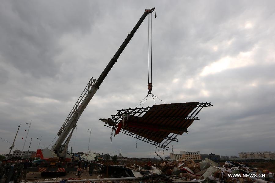 Rescuers clear wind-torn billboards in Daoxian County, central China's Hunan Province, March 20, 2013. Three people were killed and 52 others were injured by a tornado that struck the county before dawn on Wednesday. The local meteorological observatory said the wind speed of the tornado reached 30.7 meters per second, a record for the observatory. (Xinhua/Guo Guoquan)