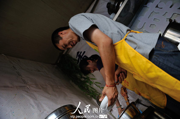 Zhao and Li keep busy in the kitchen from 9 AM in the morning till midnight.(photo/vip.peolpe.com.cn)