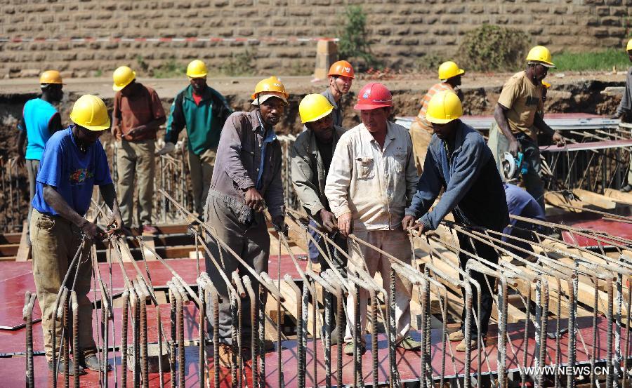 Chinese workers from the Thika project team of China Wuyi Company Limited teach local workers to tie steel bars at the construction site of a crossroad along Nairobi-Thika highway, on July 18, 2011. China-Africa economic and trade cooperation is mutually beneficial, strongly boosting the common development of the two sides. Chinese President Xi Jinping will visit Tanzania, South Africa and the Republic of Congo later this month and attend the fifth BRICS summit on March 26-27 in Durban, South Africa. (Xinhua/Zhao Yingquan) 