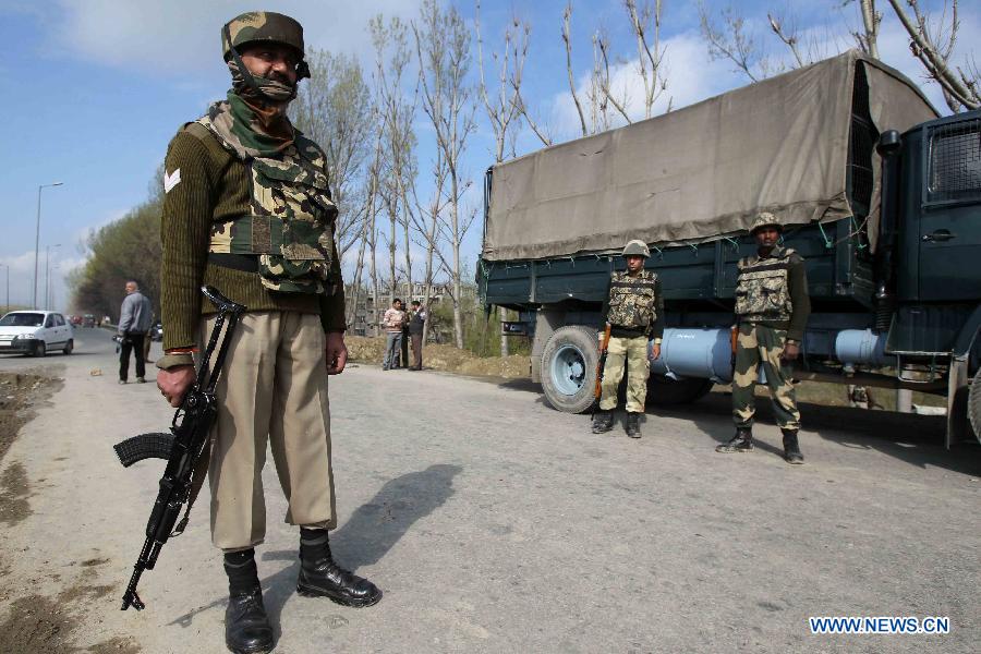 Indian border guards stand near the site of a militant attack in Srinagar, summer capital of Indian-controlled Kashmir, March 21, 2013. At least three border guards of India's Border Security Force (BSF) were wounded Thursday after gunmen ambushed their convoy in Indian-controlled Kashmir, police said. (Xinhua/Javed Dar)