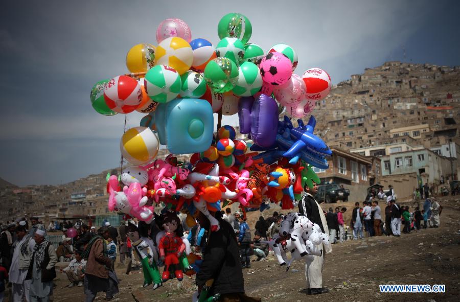 An Afghan vendor sells balloons during the celebration of Nowruz festival in Kabul, Afghanistan, March 21, 2013. Afghans celebrate the Nowruz festival as the first day of the year in Persian calendar. (Xinhua/Ahmad Massoud)