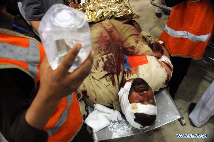 Rescuers transfer an injured man to a hospital in northwest Pakistan's Peshawar on March 21, 2013. At least 12 people were killed and 35 others injured when a bomb hit a refugee camp in Pakistan's northwest city of Nowshera on Thursday morning, local district officials said. (Xinhua/Ahmad Sidique)