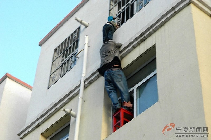 Zhou Bo risks his life to keep posture of lifting for 40 minutes. The boy was rescued by firefighters finally. (Photo/ nxnews.net)