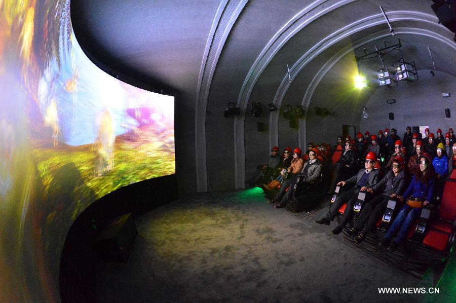 People watch a 4D movie at an underground cinema in the Kailuan national mine park in Tangshan, north China's Hebei Province, March 22, 2013. The 60-meter-deep cinema was reconstructed from a coal roadway which was built 130 years ago. The film showed in the cinema was about coal mining. (Xinhua/Zheng Yong)