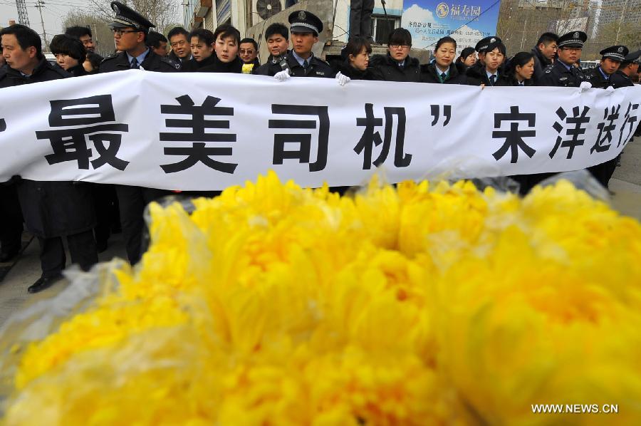 Citizens gather to bid farewell to Song Yang, the late bus driver who managed to protect passengers while he was having a stroke, in Jinan, capital of east China's Shandong Province, March 22, 2013. Song experienced a sudden brain hemorrhage while he was driving a long-distance bus carrying 33 passengers on a highway in Chiping County on the morning of March 9. He managed to slow down and park in the highway's breakdown lane, then tried his best to pull the handbrake and turn on the hazard lights. The 34-year-old driver passed away on March 20 despite being treated for days in the hospital. (Xinhua/Guo Xulei)