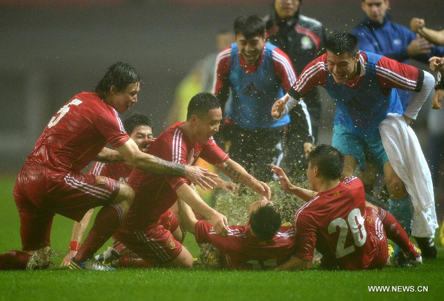 Players of the Chinese team celebrate after scoring during the 2015 AFC Asian Cup qualifier football match between China and Iraq in Changsha, capital of central China's Hunan Province, March 22, 2013. China won 1-0. (Xinhua/Guo Yong)