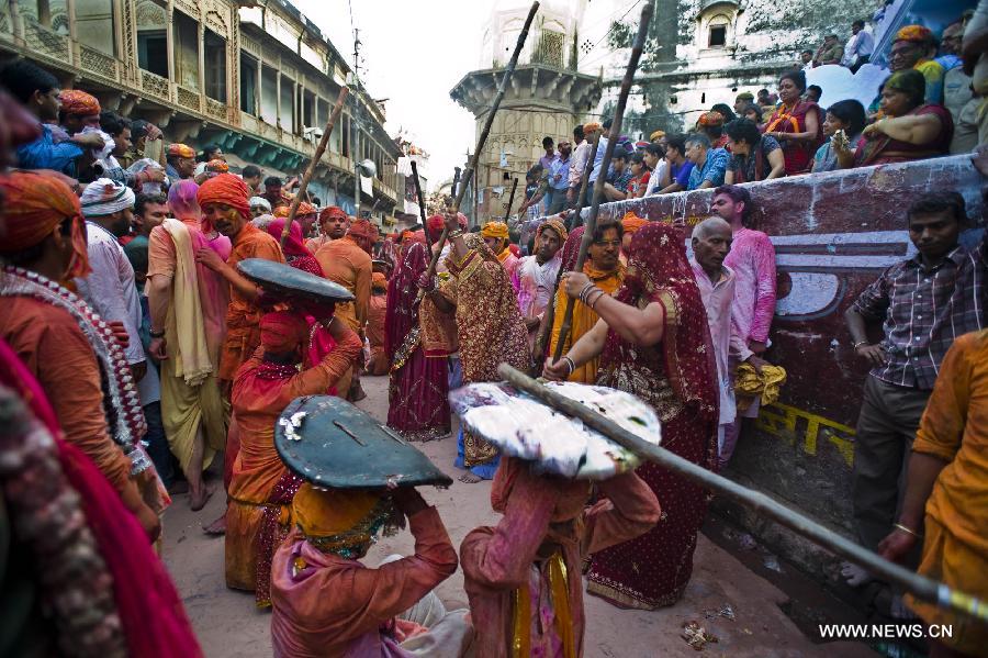 Indian women beat men with sticks during Latthmaar Holi festival at the Radha Rani temple in Barsana near Mathura city of Indian state Uttar Pradesh, March 21, 2013. (Xinhua/Tumpa Mondal) 
