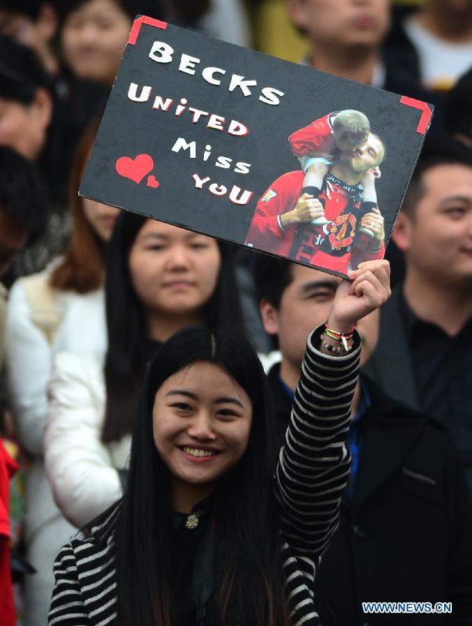 A girl holds up a banner to welcome football superstar, ambassador for the Chinese Super League (CSL) and the Youth Football Program, David Beckham at Hankou recreation and sports center in Wuhan, capital of central China's Hubei Province, March 23, 2013. (Xinhua/Cheng Min) 