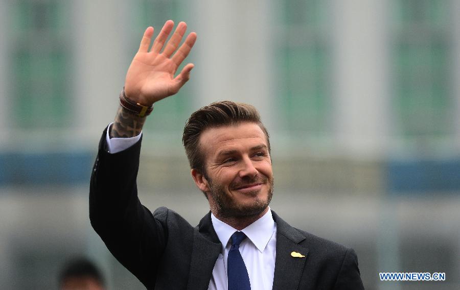 Football superstar, ambassador for the Chinese Super League (CSL) and the Youth Football Program, David Beckham waves to fans at Hankou recreation and sports center in Wuhan, capital of central China's Hubei Province, March 23, 2013. (Xinhua/Cheng Min) 