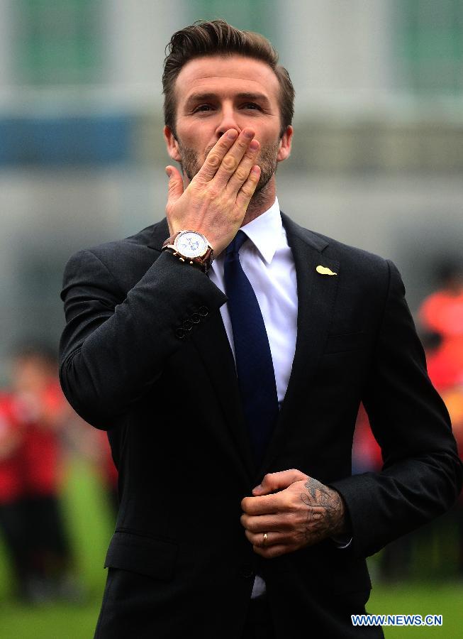 Football superstar, ambassador for the Chinese Super League (CSL) and the Youth Football Program, David Beckham greets fans at Hankou recreation and sports center in Wuhan, capital of central China's Hubei Province, March 23, 2013. (Xinhua/Cheng Min) 