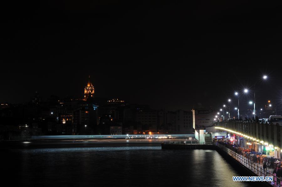 The Galata Tower turns on the lights after the annual "Earth Hour" event in Istanbul of Turkey on March 23, 2013. (Xinhua/Ma Yan) 