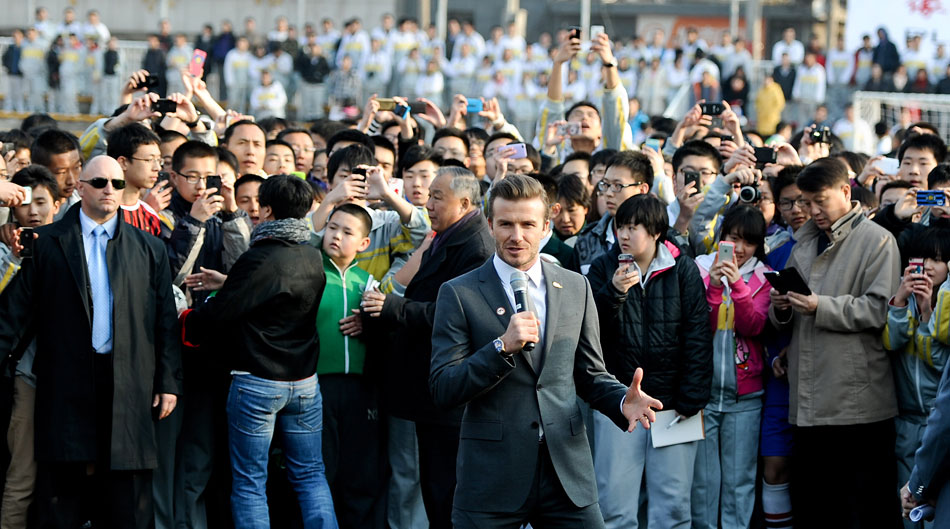 David Beckham (front) talks with students of Beijing No. 2 High School after playing football with them in Beijing, China on March 20, 2013. Beckham came to China to promote football as the ambassador for the youth football program in China and the Chinese Super League (CSL). (Xinhua/Cao Can)