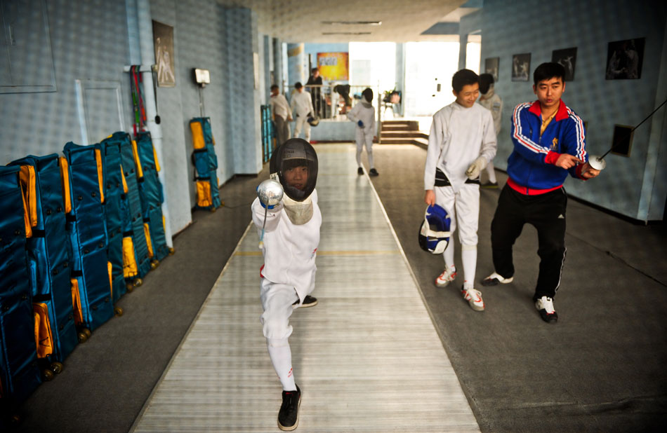 A boy practices the fundamental movements of fencing, China’s Tianjing, March 16, 2013. (Xinhua/Zhang Chaoqun)