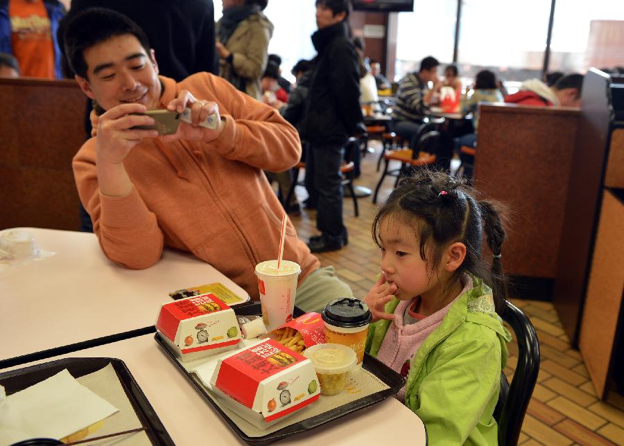 Former employee Zhang Tao takes his daughter to the McDonald's restaurant at Chang'an Market for a nostalgia tour in Beijing, capital of China, March 24, 2013. Opened in 1993 as the second outlet of the American fast-food giant in Beijing, the Chang'an Market McDonald's made indelible impressions on locals. Due to reconstruction and adjustment of the market, the outlet outlet discontinued its business Sunday. (Xinhua/Li Xin)