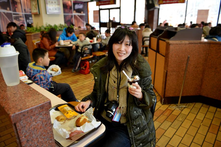 Yu Ting visits the McDonald's restaurant at Chang'an Market for a nostalgia tour, where she shared happy hours with her cousin as teenagers, in Beijing, capital of China, March 24, 2013. Opened in 1993 as the second outlet of the American fast-food giant in Beijing, the Chang'an Market McDonald's made indelible impressions on locals. Due to reconstruction and adjustment of the market, the outlet discontinued its business Sunday. (Xinhua/Li Xin)
