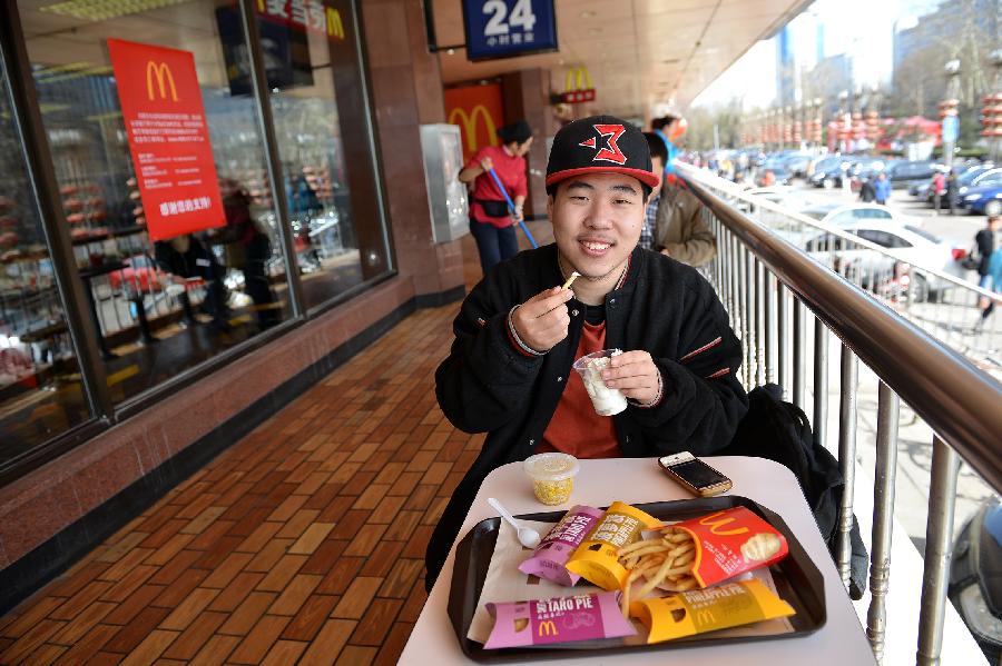 21-year-old Tian Shengguang visits the McDonald's restaurant at Chang'an Market for a nostalgia tour in Beijing, capital of China, March 24, 2013. Opened in 1993 as the second outlet of the American fast-food giant in Beijing, the Chang'an Market McDonald's made indelible impressions on locals. Due to reconstruction and adjustment of the market, the outlet discontinued its business Sunday. (Xinhua/Li Xin)