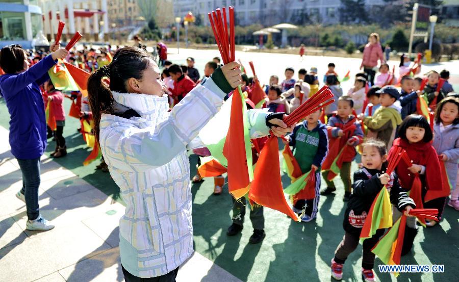 Teachers lead children of Mongolian ethnic group to do morning exercises adapted from folk dance at a kindergarten in Hohhot, capital of north China's Inner Mongolia Autonomous Region, March 25, 2013. The region has promoted education on ethnic culture for kindergarten children of Mongolian ethnic group, by offering children classes on folk music, dance and drawing. (Xinhua/Zhao Tingting) 