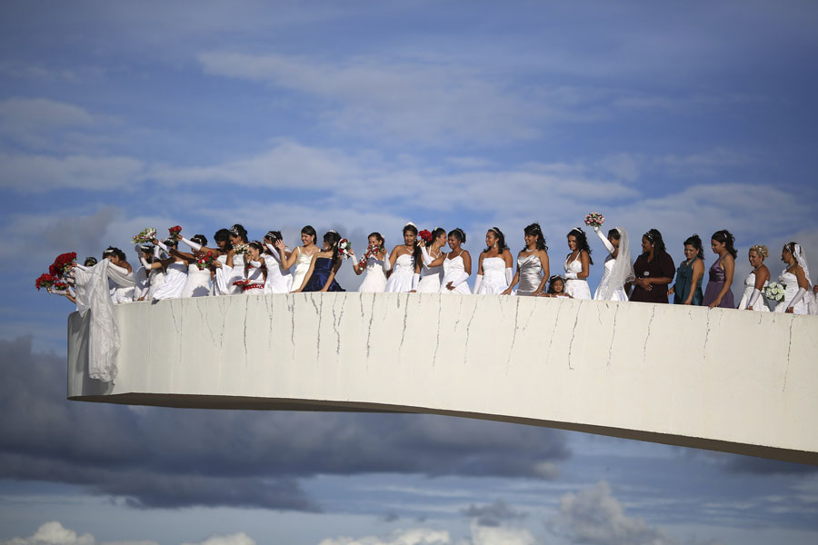 Brides pose for photos before their mass wedding ceremony at the Museum of the Republic in Brasilia, March 23, 2013. (Xinhua / Reuters)