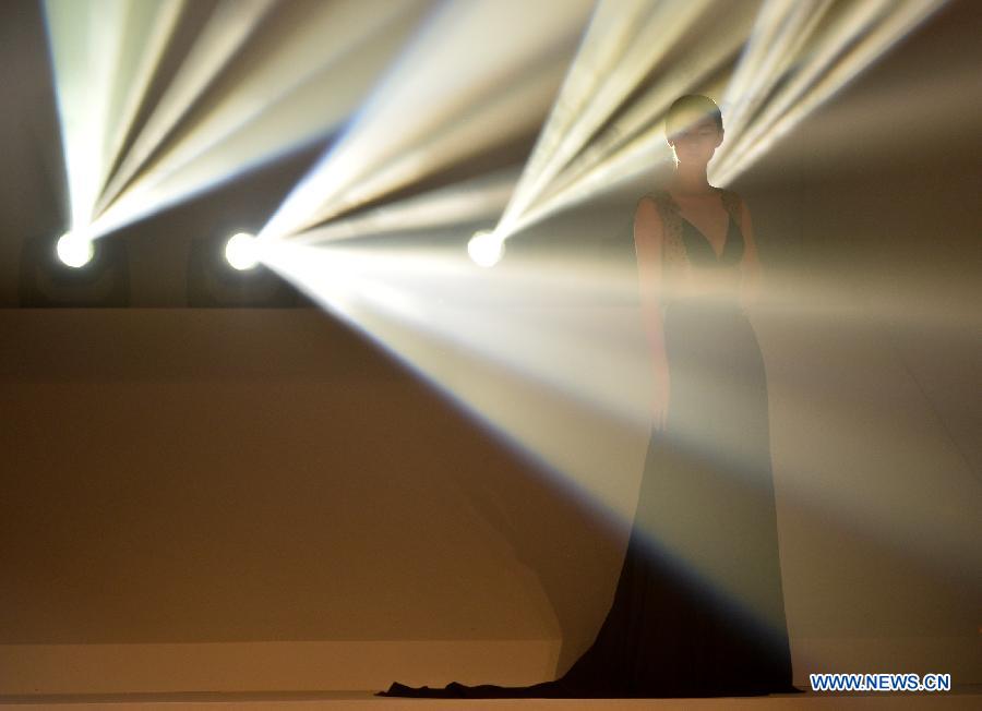 A model presents a creation of designers attending the 21st China International Young Fashion Designers Contest in Beijing, capital of China, March 25, 2013. The contest theming Boundary has attracted 29 designers from 16 countries. (Xinhua/Li Xin)