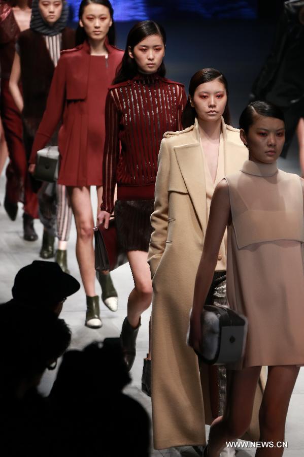 Models present creations by Italian designer Gabriele Colangelo during the China Fashion Week in Beijing, capital of China, March 25, 2013. (Xinhua/Li Mingfang) 