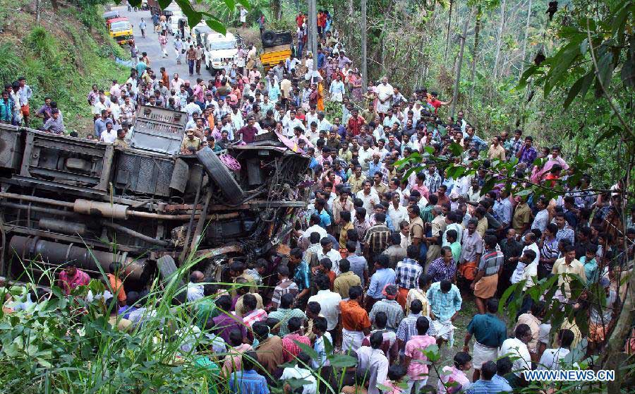 Local residents gather at the site of a bus accident at Idukki district of India's southern state Kerala, March 25, 2013. A school bus carrying students from Sarabhai Institute of Science and Technology fell into a deep ditch on Monday. (Xinhua/Stringer)