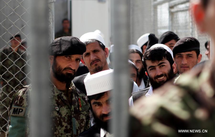 Afghan prisoners wait for their release from Bagram prison during an official ceremony to hand over Bagram prison to the Afghan government in Parwan province, north of Kabul, capital of Afghanistan, on March 25, 2013. The Afghan Defense Ministry took the full control of a key U.S.-run detention center often called the Bagram prison on Monday, a fresh development of the security transition plan that lasts till 2014 when Afghanistan is due to take over the full security duties from U.S. and NATO forces. (Xinhua/Ahmad Massoud)