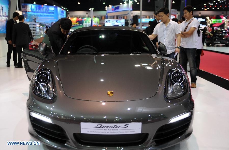 Visitors view a Ferrari roadster during the press preview of the 34th Bangkok International Motor Show in Bangkok, Thailand, on March 26, 2013. The 34th Bangkok International Motor Show will be held from March 27 to April 7. (Xinhua/Gao Jianjun) 