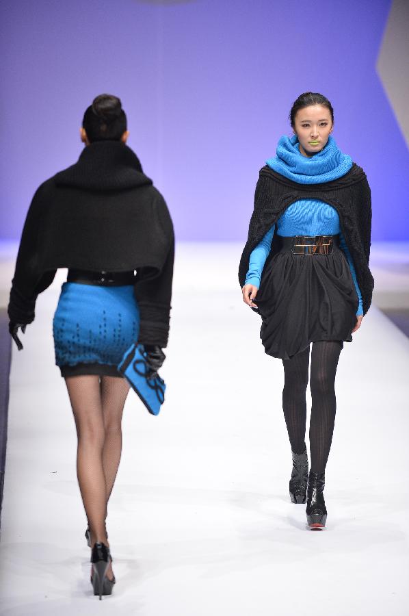 Models present creations in the WSM China Knitwear Fashion Design Contest 2013 during the China Fashion Week in Beijing, capital of China, March 26, 2013. The design by Sheng Lina from Fashion School & Engineering of Zhejiang Sci-Tech University won the championship of the contest. (Xinhua/Li Xin) 