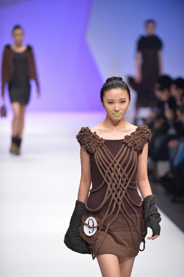 A model presents a creation in the WSM China Knitwear Fashion Design Contest 2013 during the China Fashion Week in Beijing, capital of China, March 26, 2013. The design by Sheng Lina from Fashion School & Engineering of Zhejiang Sci-Tech University won the championship of the contest. (Xinhua/Li Xin) 