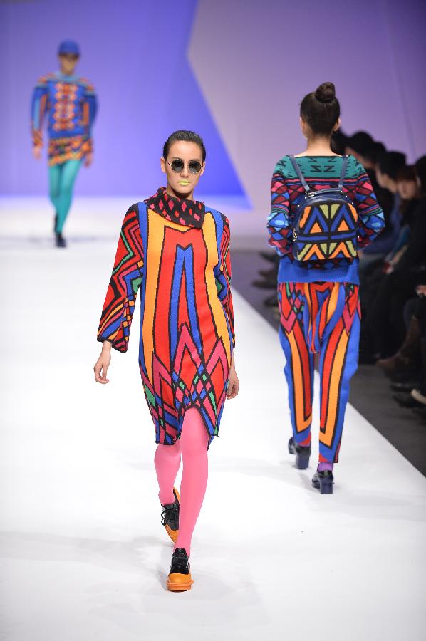 Models present creations in the WSM China Knitwear Fashion Design Contest 2013 during the China Fashion Week in Beijing, capital of China, March 26, 2013. The design by Sheng Lina from Fashion School & Engineering of Zhejiang Sci-Tech University won the championship of the contest. (Xinhua/Li Xin) 