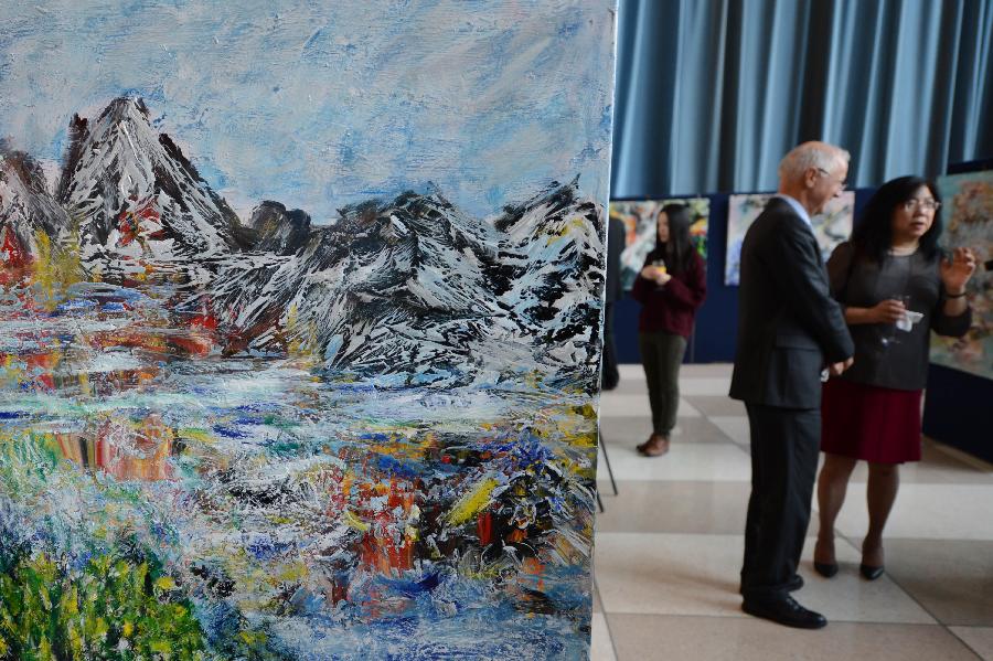 Visitors view oil paintings on display during an exhibiton entitled "A Semblance Great: The Shadow of a Shade", at the United Nations headquarters in New York, the United States, on March 26, 2013. The exhibition consisted of 38 oil paintings by artist Li Hongtao, who was renowned for his unique style of painting. (Xinhua/Niu Xiaolei) 