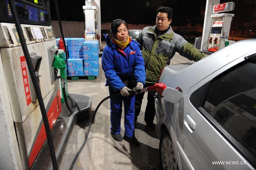 A staff member refuels a car at a gas station in Urumqi, capital of northwest China's Xinjiang Uygur Autonomous Region, March 27, 2013. China cut the retail prices of gasoline by 310 yuan (49.43 U.S. dollars) per tonne and diesel by 300 yuan per tonne starting Wednesday. The National Development and Reform Commission (NDRC) also announced a new pricing system which will adjust the prices of oil products every 10 working days to better reflect changes in the global oil market. (Xinhua/Jiang Wenyao)
