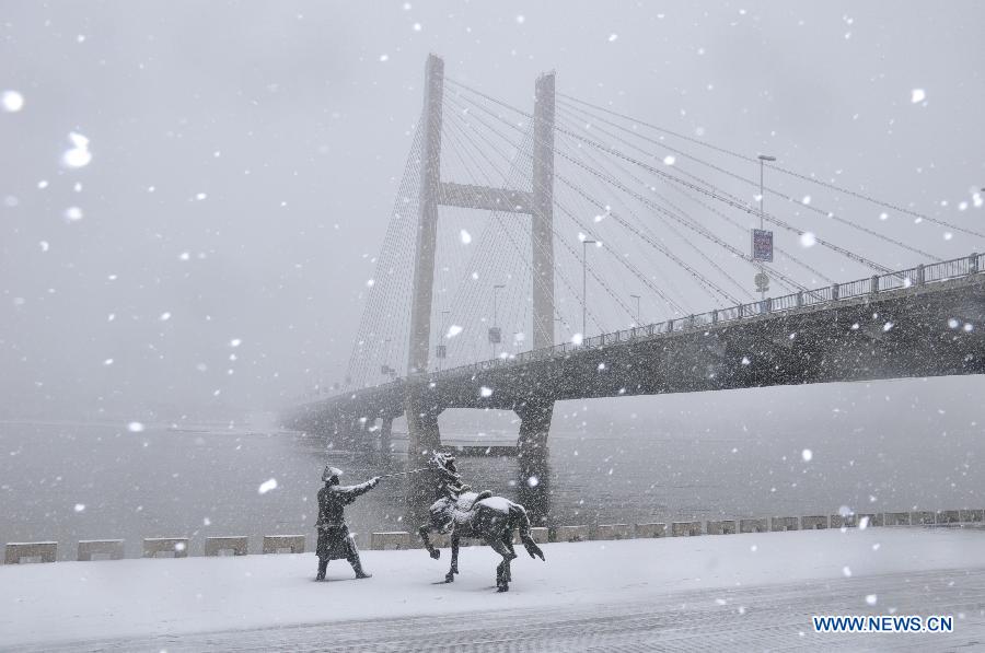 Sculptures and a bridge are seen in snow in Jilin City, northeast China's Jilin Province, March 27, 2013. (Xinhua/Wang Mingming) 