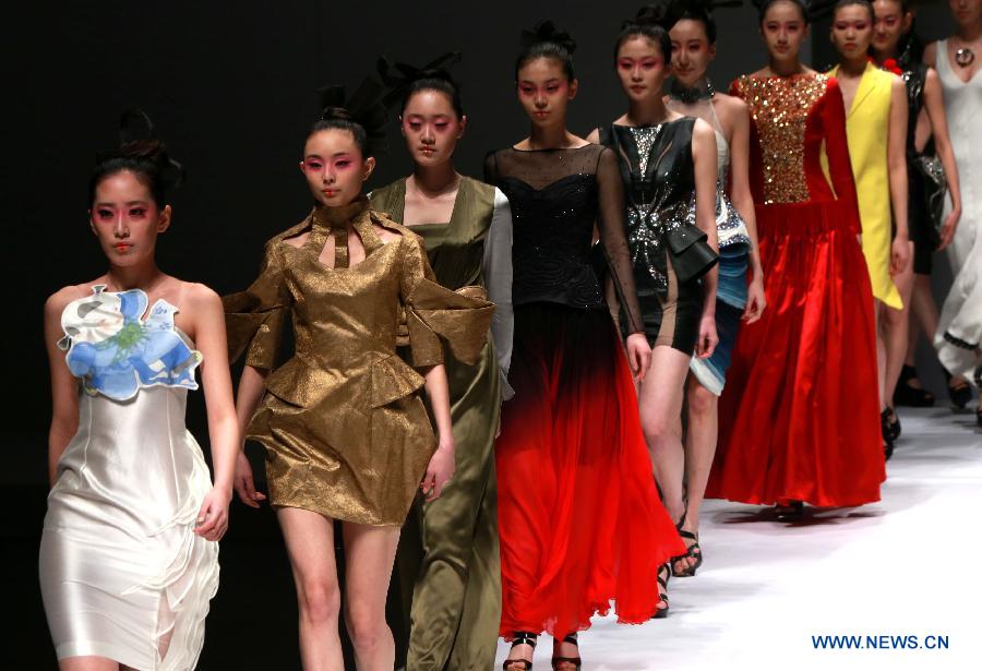 Models present creations designed by students of Minzu University of China during the China Fashion Week in Beijing, capital of China, March 27, 2013. (Xinhua/Li Mingfang) 