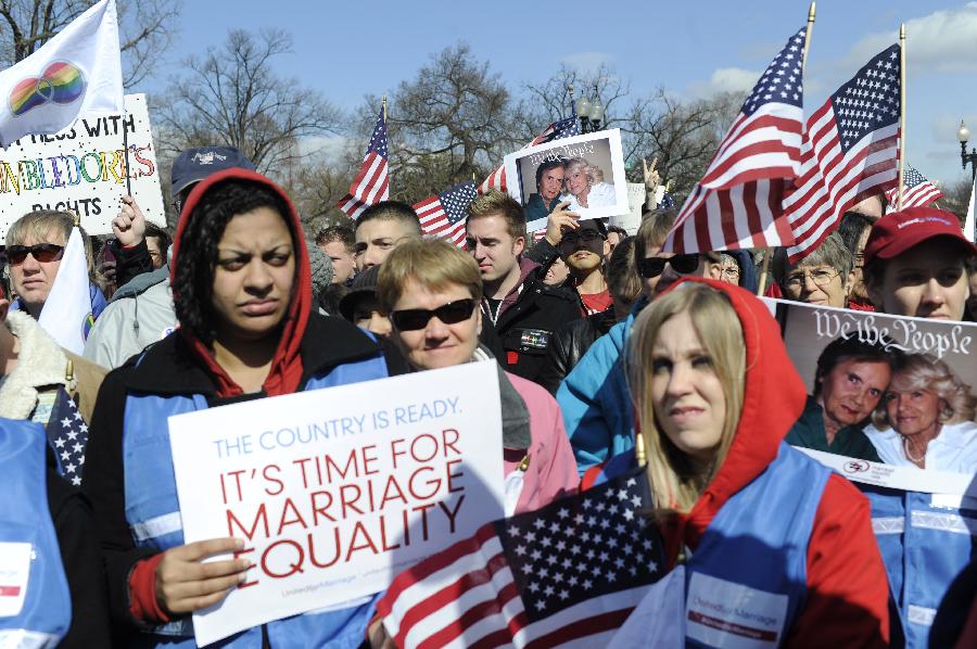 Supporters of same-sex marriage rally outside the U.S. Supreme Court in Washington D.C., capital of the United States, March 27, 2013. The U.S. Supreme Court heard arguments on Wednesday in the case of "United States v. Windsor", whether the Defense of Marriage Act (DOMA) violates the Fifth Amendment's guarantee of equal protection of the laws as applied to persons of the sam sex who are legally married under the laws of their State. (Xinhua/Zhang Jun) 