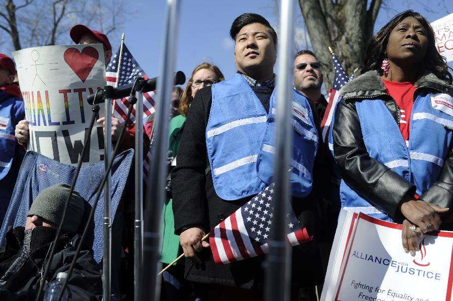 Supporters of same-sex marriage rally outside the U.S. Supreme Court in Washington D.C., capital of the United States, March 27, 2013. The U.S. Supreme Court heard arguments on Wednesday in the case of "United States v. Windsor", whether the Defense of Marriage Act (DOMA) violates the Fifth Amendment's guarantee of equal protection of the laws as applied to persons of the sam sex who are legally married under the laws of their State. (Xinhua/Zhang Jun) 