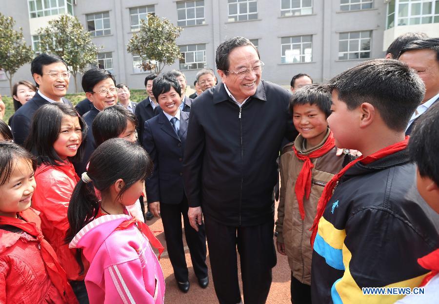 Yu Zhengsheng, a member of the Standing Committee of the Political Bureau of the Communist Party of China (CPC) Central Committee, who is also chairman of the National Committee of the Chinese People's Political Consultative Conference (CPPCC), talks to pupils of a primary school in Pudi Township in Bijie City, southwest China's Guizhou Province, March 25, 2013. Yu was on an inspection tour in Guizhou from March 24 to March 27. (Xinhua/Yao Dawei) 