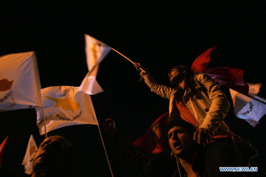 Thousands of Cypriots demonstrate to protest against the harsh treatment imposed on Cyprus by the Eurogroup, in the streets of Nicosia, Cyprus on March 27, 2013. The Mediterranean island and the Troika struck a 10 billion euro bailout deal in Brussels on March 25. The new agreement requires radical reshaping of the Cypriot banking system and massive "haircuts" on Cypriots who have more than 100,000 Euros deposited in banks. Many bank employees may lose their jobs. (Xinhua/Marios Lolos) 