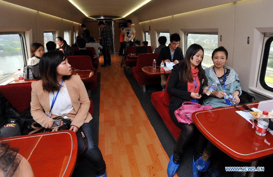 Media and railway workers take a bullet train during a test run of the Nanjing-Hangzhou High-Speed Railway on March 28, 2013. The new Nanjing-Hangzhou High-Speed Railway is a supplement to railway travelling within China's Yangtze River Delta. The 249-kilometer rail line will reduce travel time from Nanjing to Hangzhou to about an hour. (Xinhua/Wang Dingchang)