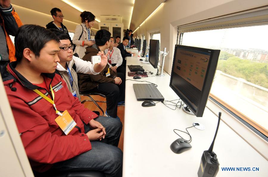 Workers keep track of a bullet train's operational data during a test run of the Nanjing-Hangzhou High-Speed Railway on March 28, 2013. The new Nanjing-Hangzhou High-Speed Railway is a supplement to railway travelling within China's Yangtze River Delta. The 249-kilometer rail line will reduce travel time from Nanjing to Hangzhou to about an hour. (Xinhua/Wang Dingchang)
