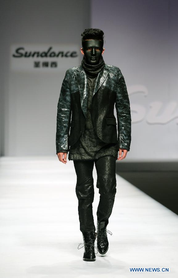 A model presents a creation during the 2013 "Sundance Cup" China Fashion Business Men's Clothing Design Competition in Beijing, capital of China, March 27, 2013. A total of 600 creations participated in the competition held in Beijing on Thursday. (Xinhua/Wan Xiang)