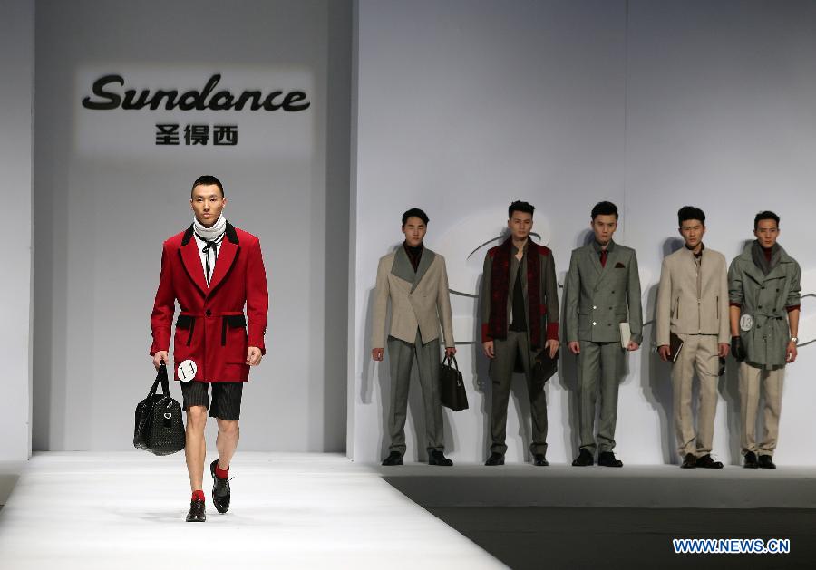 A model presents a creation during the 2013 "Sundance Cup" China Fashion Business Men's Clothing Design Competition in Beijing, capital of China, March 27, 2013. A total of 600 creations participated in the competition held in Beijing on Thursday. (Xinhua/Wan Xiang)