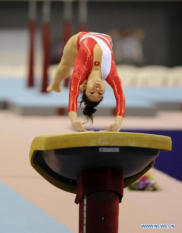 Phan Thi Ha Thanh of Vietnam performs during the women's vault final at the 6th FIG Artistic Gymnastics world Challenge Cup in Doha, Qatar, March 28, 2013. Phan Thi Ha Thanh claimed the title with 14.825 points. (Xinhua/Chen Shaojin)