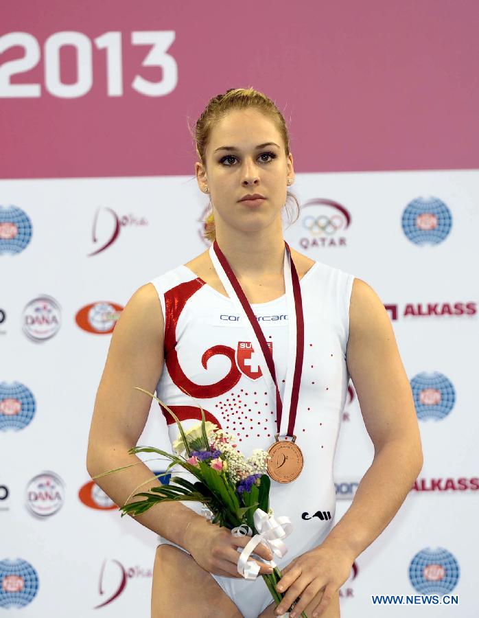 Giulia Steingruber of Switzerland reacts during the awarding ceremony for women's vault at the 6th FIG Artistic Gymnastics world Challenge Cup in Doha, Qatar, March 28, 2013. Steingruber took the bronze medal with 14.662 points. (Xinhua/Chen Shaojin)