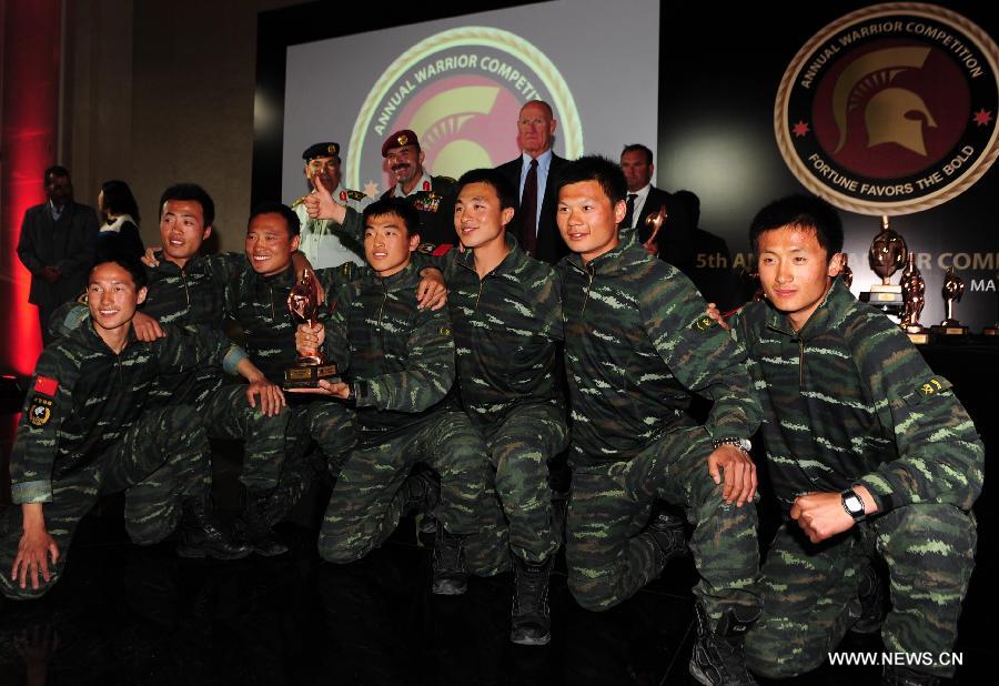Members of Chinese People's Armed Police team receive the first prize of the 5th Warrior Competition in Amman, Jordan, March 28, 2013. Chinese People's Armed Police team on Thursday won the first prize of fifth Warriors contest "international special forces contest at King Abdullah Special Operation Training Center (KASOTC) in Amman. The competition with wide participation of 33 teams from 18 countries was held from March 24 to March 28. (Xinhua/Cheng Chunxiang)  