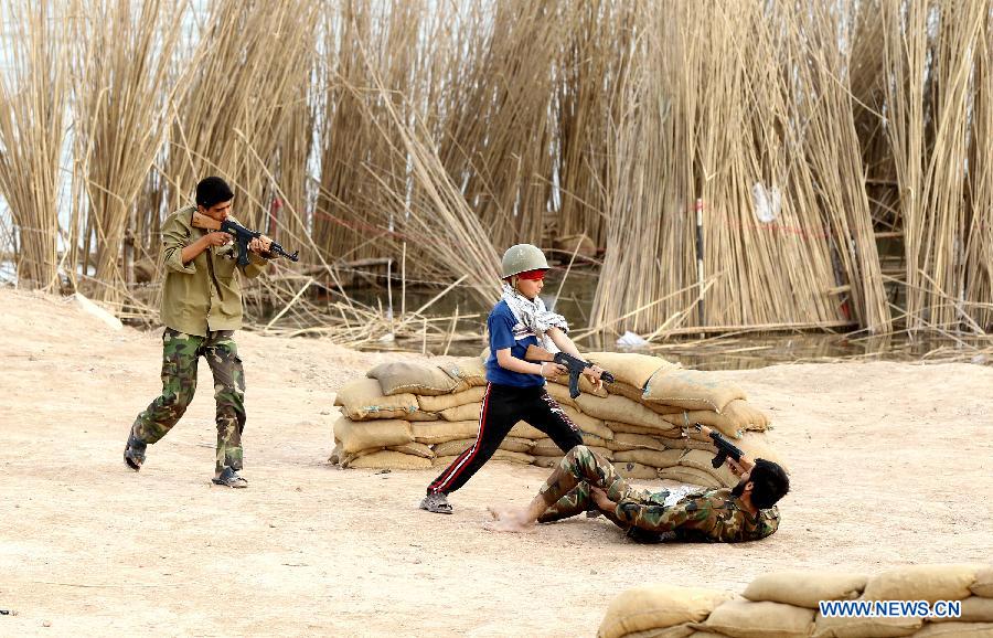 Iranian boys play at Talaeiyeh, a battlefield of the 1980-1988 Iran-Iraq war, in Iran's southwestern province of Khuzestan, during the Iranian New Year holidays on March 29, 2013. (Xinhua/Ahmad Halabisaz) 