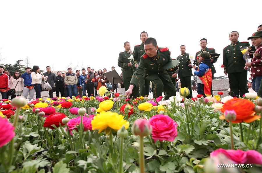 Soldiers present flowers at a monument during a memorial ceremony held at Yuhuatai Martyr Cemetery in Nanjing, capital of east China's Jiangsu Province, March 30, 2013. Various memorial ceremonies were held across the country to pay respect to martyrs ahead of the Qingming Festival, or Tomb Sweeping Day, which falls on April 4 this year. (Xinhua)